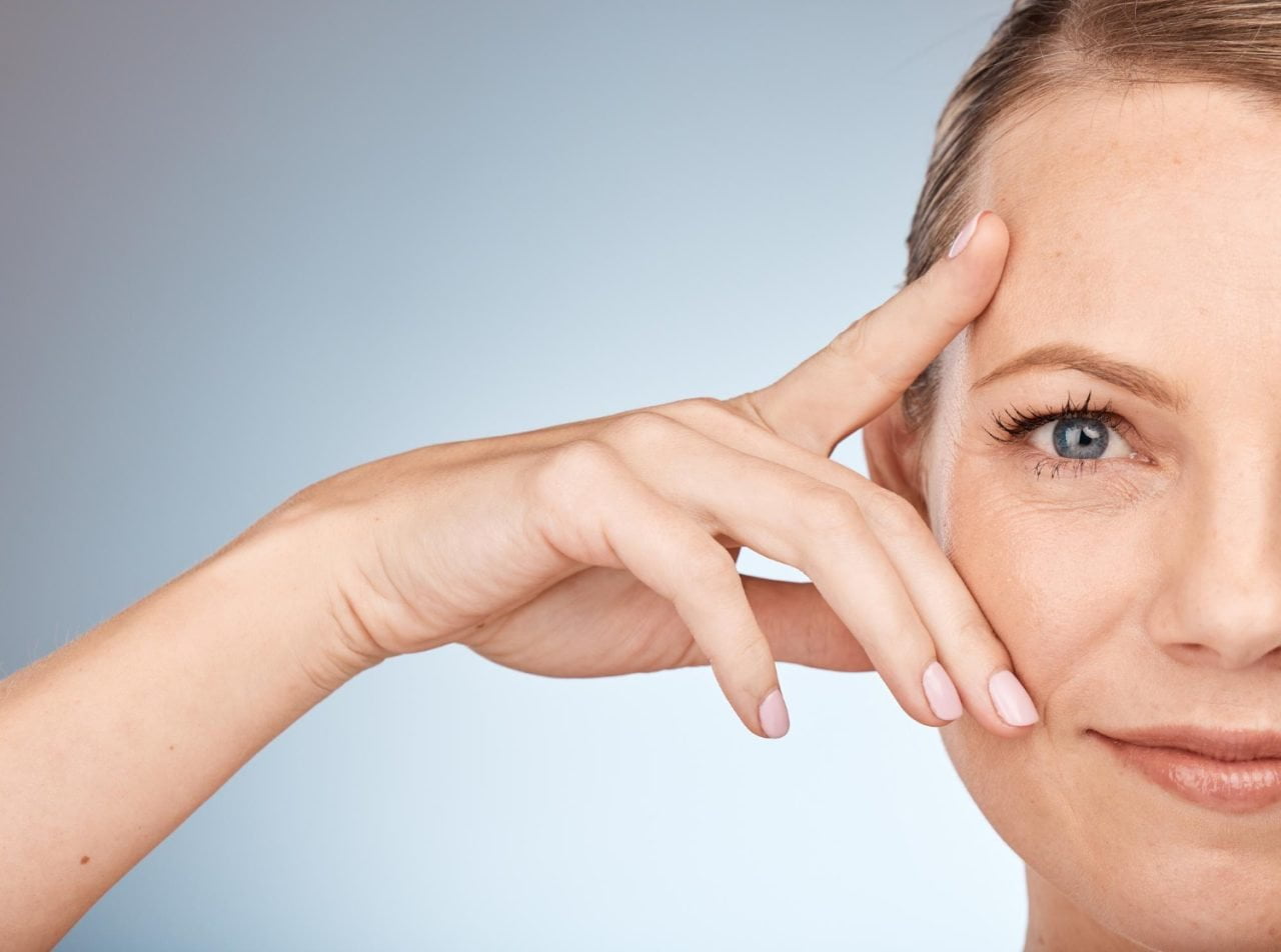 white lady with hand on her eye