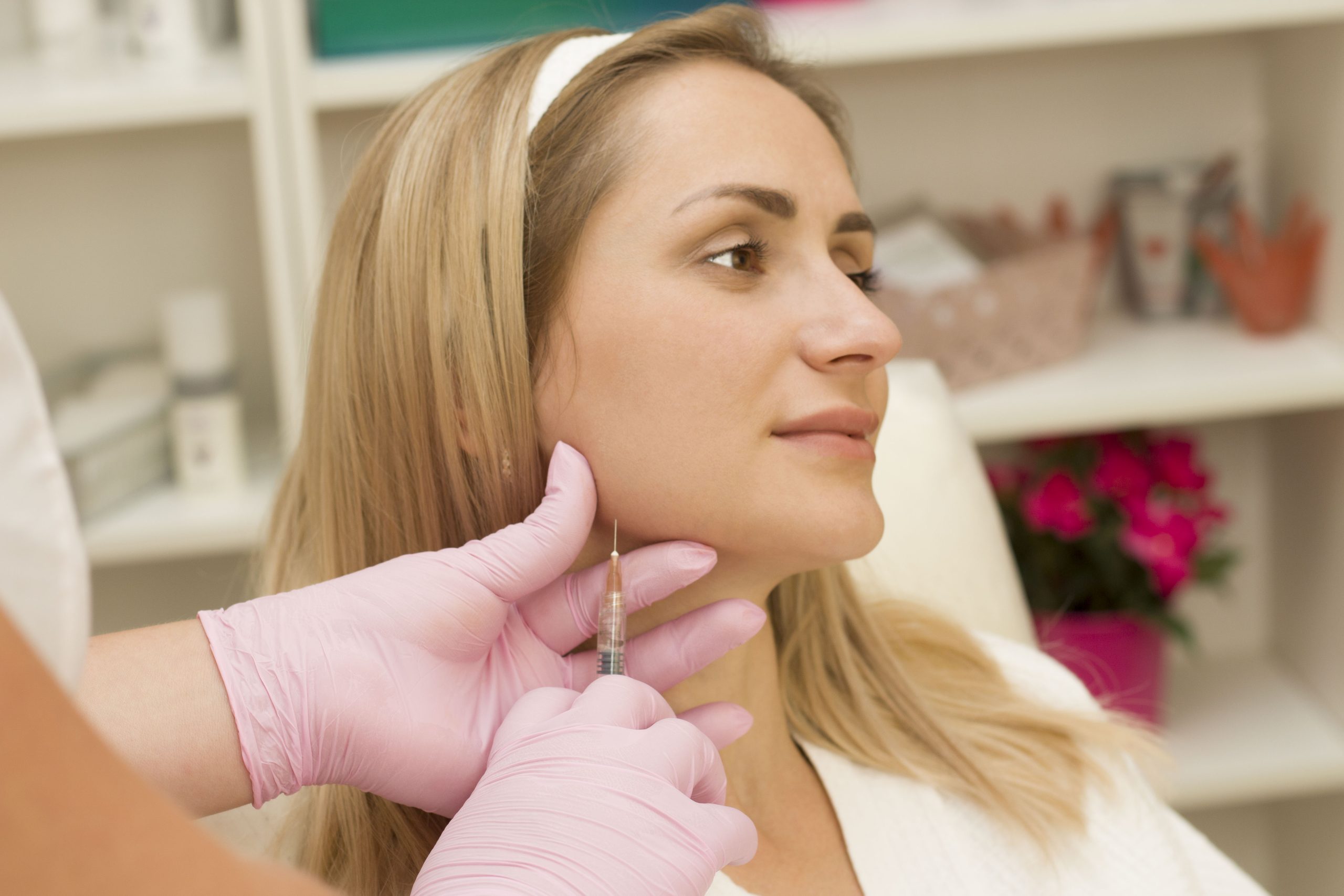 young woman is given a chin filler