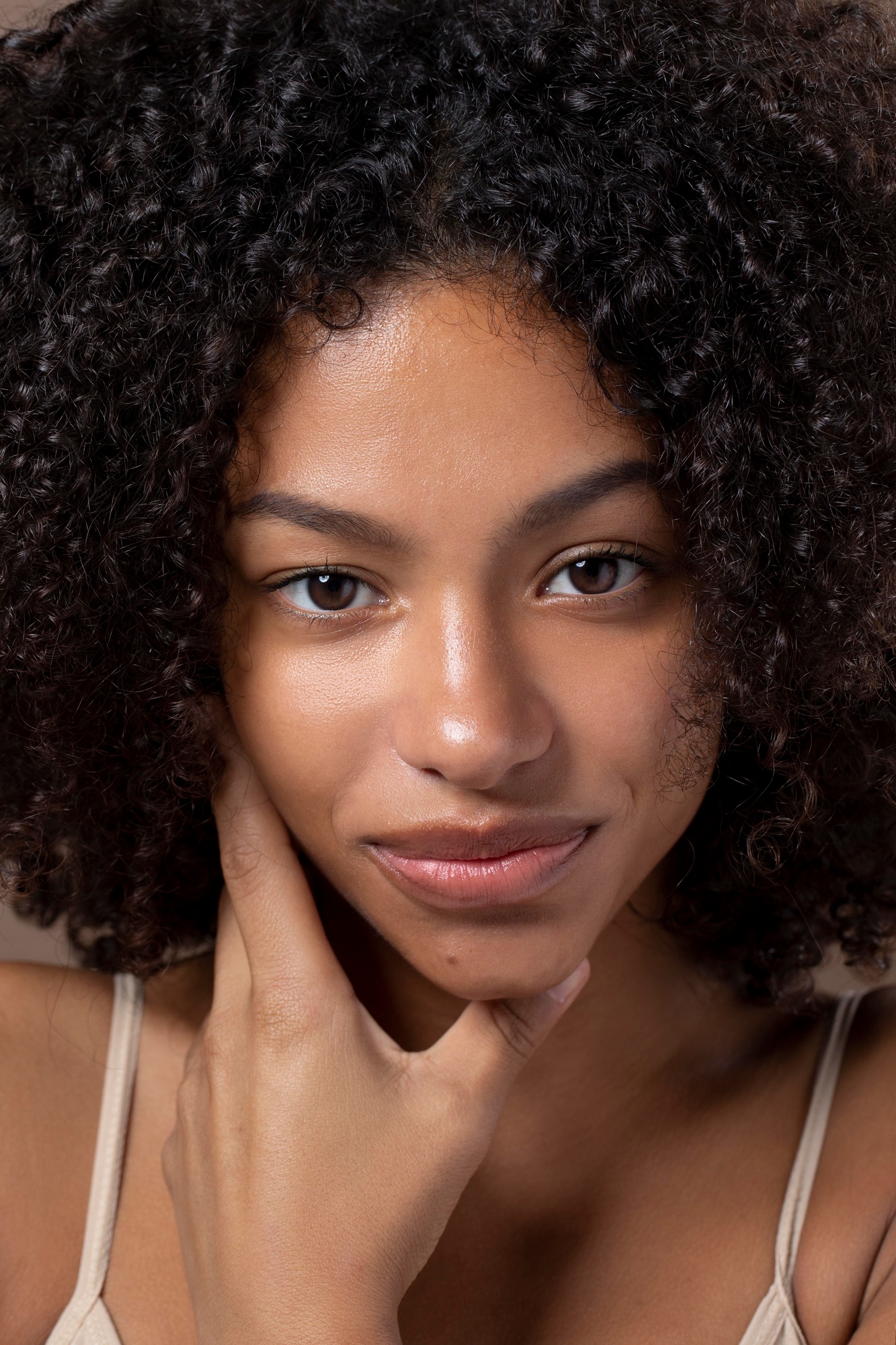 Natural beauty portrait of a woman with curly hair.
