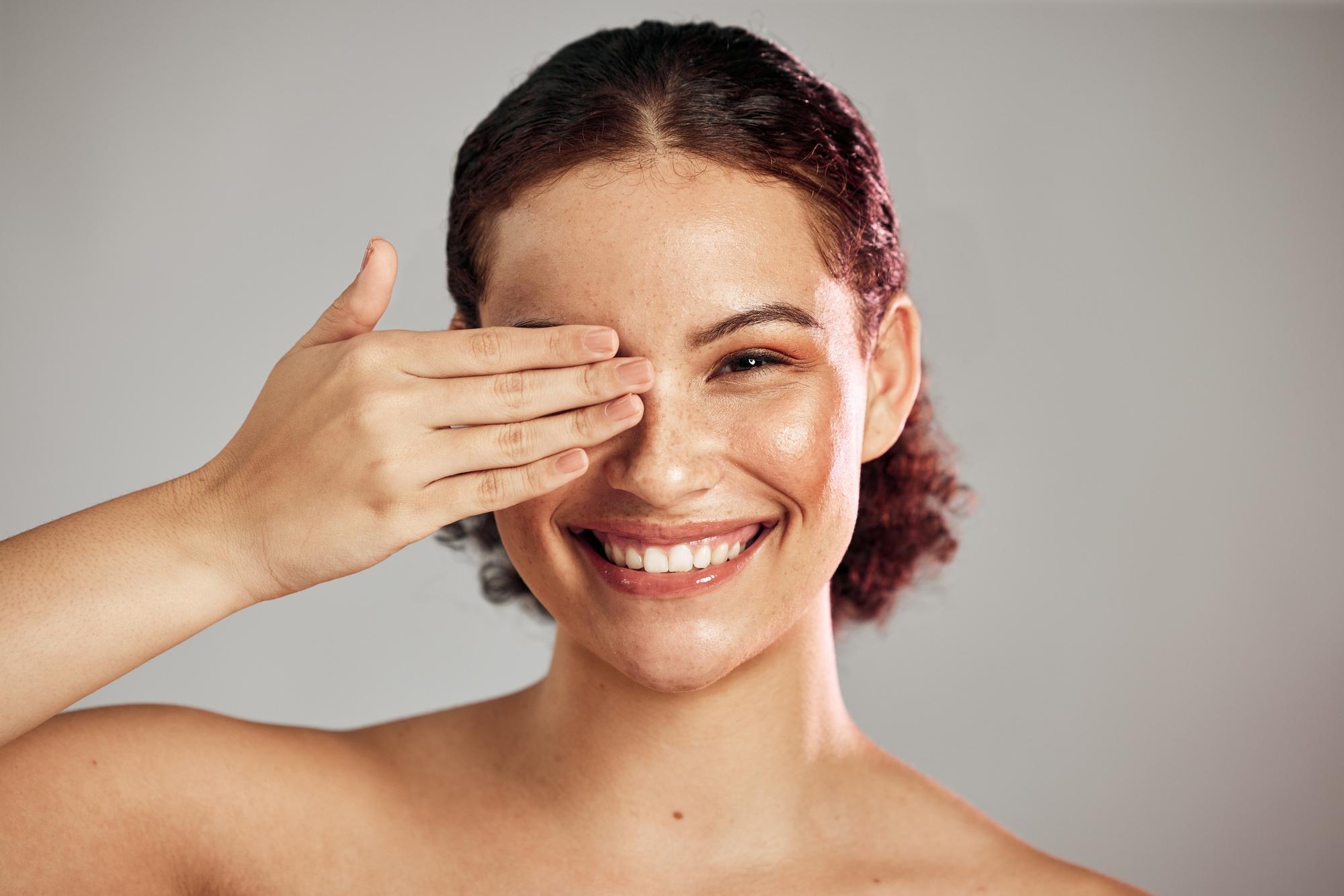 Smiling woman with smooth skin against a white background.