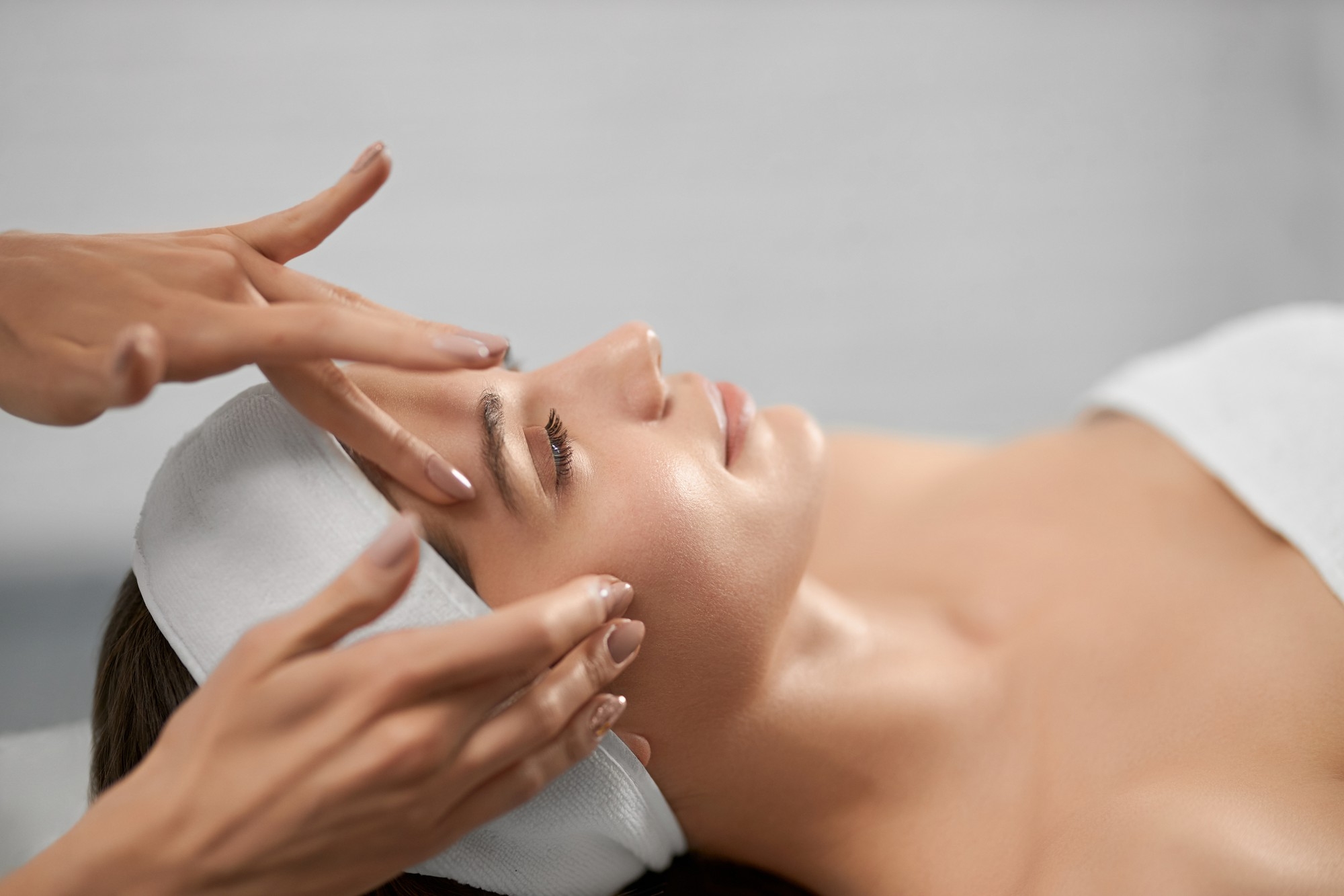 Woman receiving a facial massage during a spa skincare treatment.