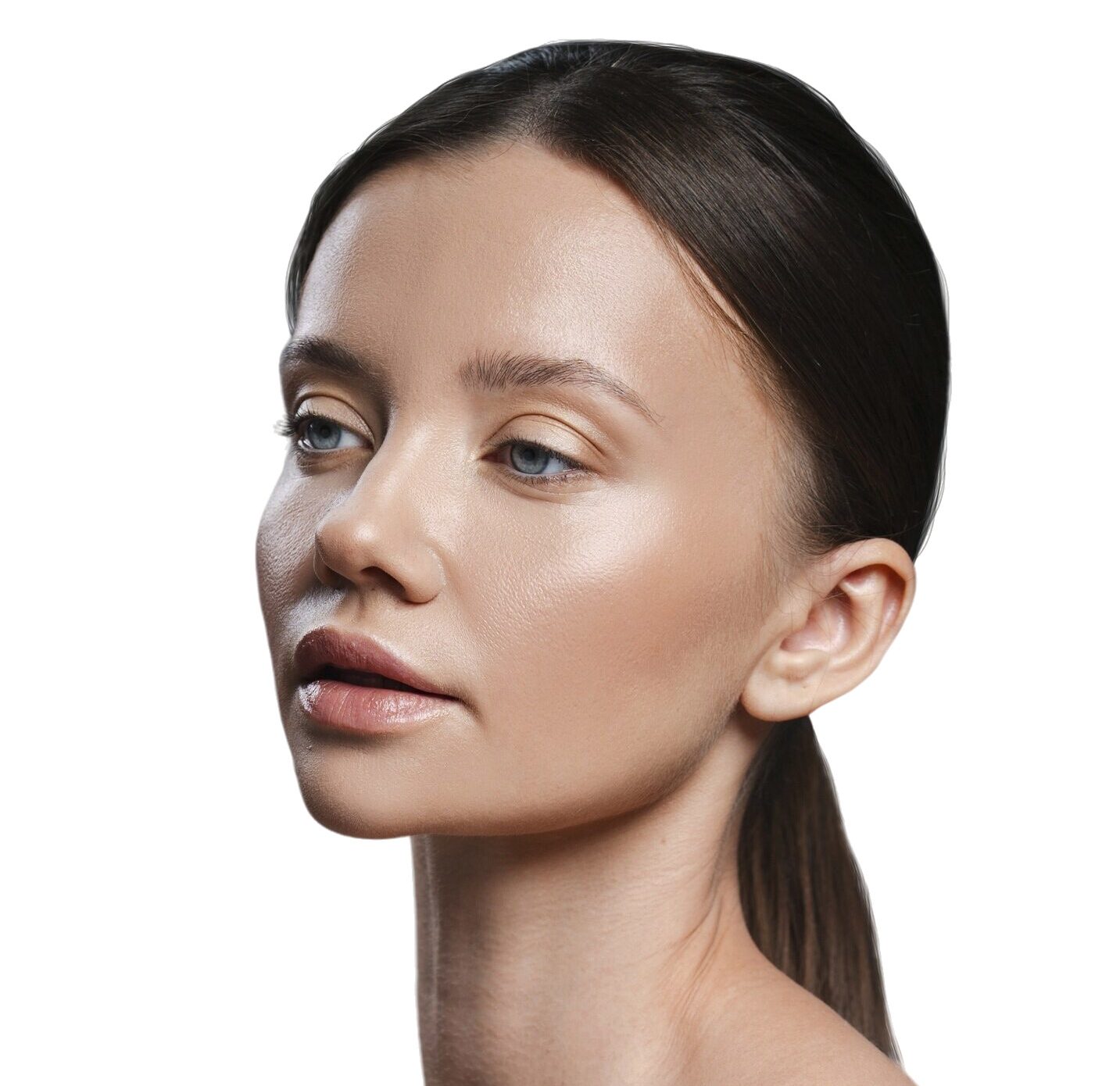 Profile portrait of a woman with smooth, glowing skin and a sleek ponytail against a white background